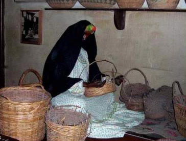 Display of a women weaving baskets