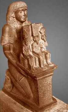 Statue of worshipper presenting votive of Mut, Amun and Khonus