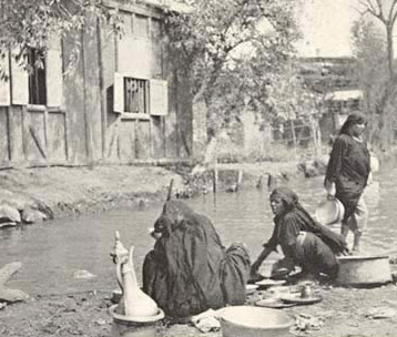 Village idyll - an everyday canal-side scene at washing-up time